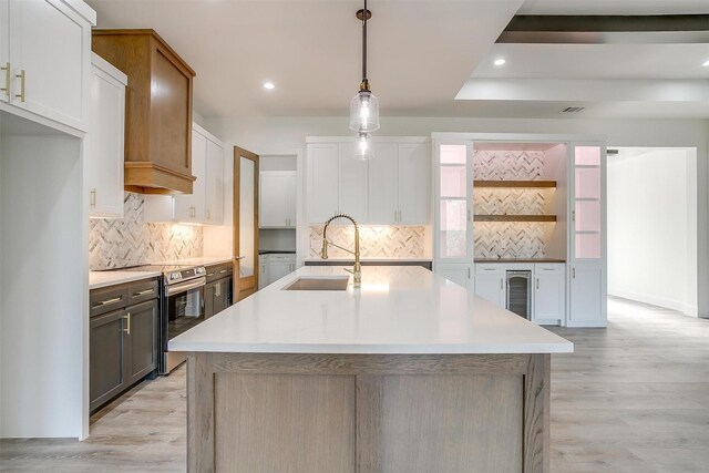 224 Ash Creek Dr W, Azle, TX 76020 - kitchen with light wood-type flooring, wine cooler, a sink, and stainless steel electric range oven