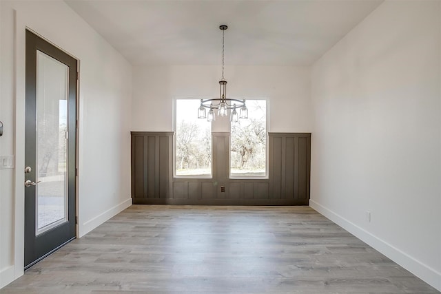 224 Ash Creek Dr W, Azle, TX 76020 - unfurnished dining area with baseboards, a chandelier, and light wood finished floors