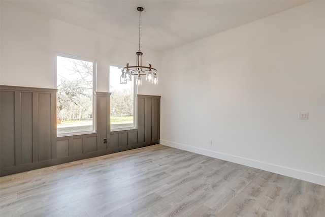 224 Ash Creek Dr W, Azle, TX 76020 - unfurnished dining area featuring baseboards, an inviting chandelier, and light wood-style floors