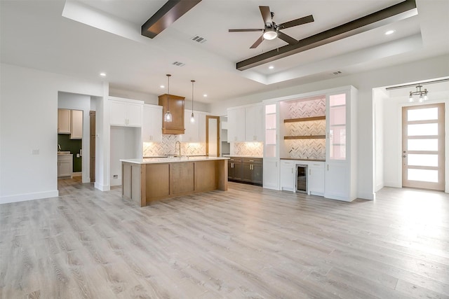 224 Ash Creek Dr W, Azle, TX 76020 - kitchen featuring beam ceiling, wine cooler, light wood finished floors, and decorative backsplash