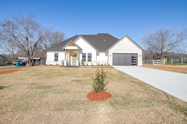 224 Ash Creek Dr W, Azle, TX 76020 - view of front facade with concrete driveway, fence, board and batten siding, a front lawn, and a garage