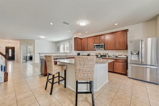 2224 Loreto Dr, Fort Worth, TX 76177 - kitchen with light stone countertops, recessed lighting, light tile patterned floors, visible vents, and stainless steel appliances