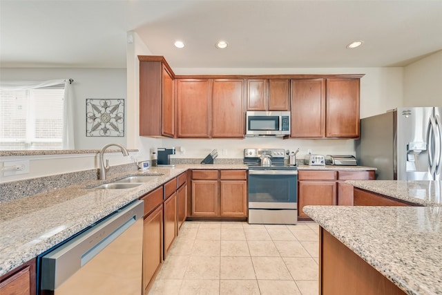 2224 Loreto Dr, Fort Worth, TX 76177 - kitchen featuring light tile patterned floors, appliances with stainless steel finishes, light stone countertops, and a sink