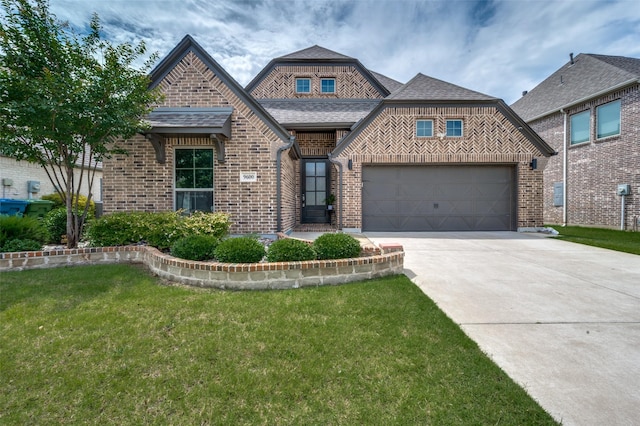 9600 Blue Stem Ln, Little Elm, TX 75068 - view of front of property featuring brick siding, driveway, a front yard, a garage, and a shingled roof