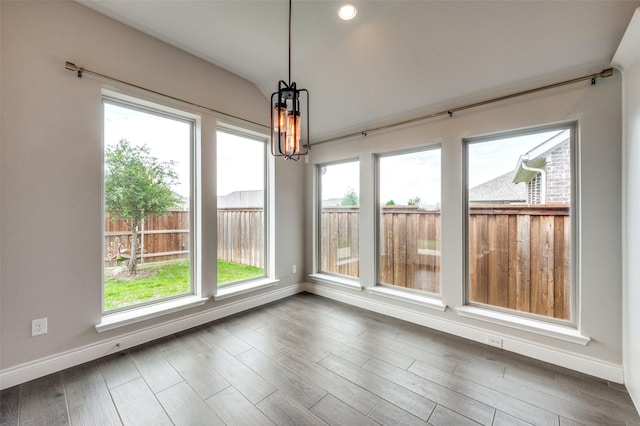 9600 Blue Stem Ln, Little Elm, TX 75068 - unfurnished sunroom with baseboards, a chandelier, wood finished floors, and vaulted ceiling
