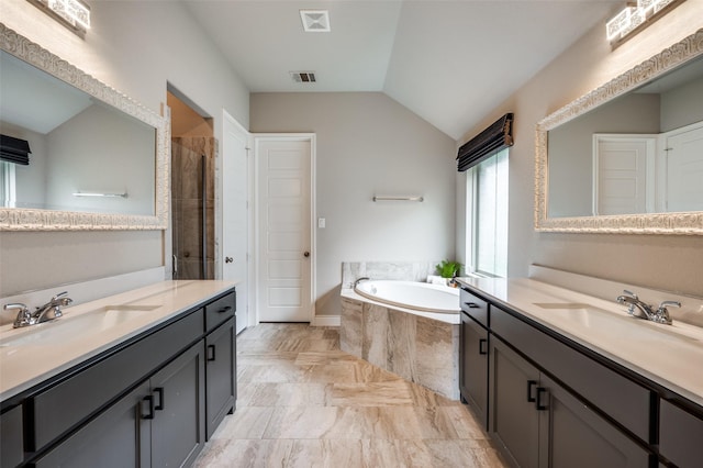9600 Blue Stem Ln, Little Elm, TX 75068 - full bathroom with lofted ceiling, two vanities, a bath, a stall shower, and marble finish floors