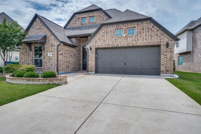 9600 Blue Stem Ln, Little Elm, TX 75068 - view of front of house featuring brick siding, driveway, roof with shingles, and a garage