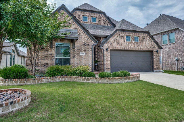 9600 Blue Stem Ln, Little Elm, TX 75068 - view of front of home featuring brick siding, concrete driveway, a front yard, and roof with shingles
