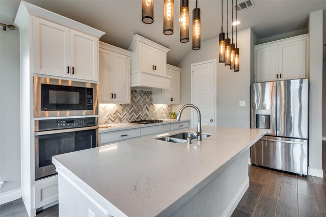 9600 Blue Stem Ln, Little Elm, TX 75068 - kitchen featuring stainless steel appliances, a sink, decorative backsplash, dark wood-style flooring, and baseboards
