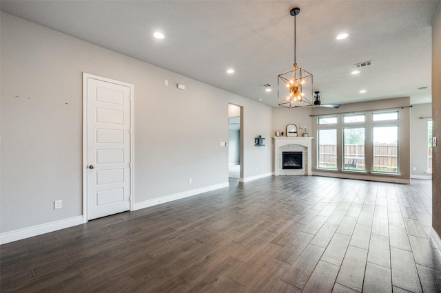 9600 Blue Stem Ln, Little Elm, TX 75068 - unfurnished living room featuring dark wood-type flooring, recessed lighting, baseboards, a ceiling fan, and a chandelier