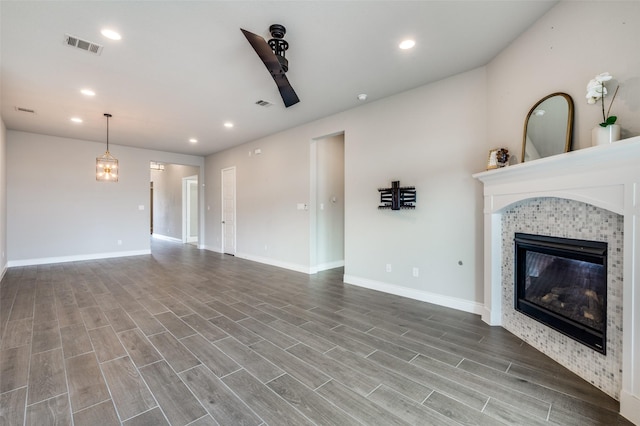 9600 Blue Stem Ln, Little Elm, TX 75068 - unfurnished living room featuring a tiled fireplace, wood finished floors, baseboards, recessed lighting, and ceiling fan