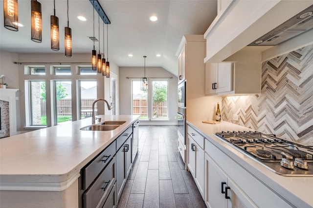 9600 Blue Stem Ln, Little Elm, TX 75068 - kitchen with a sink, premium range hood, stainless steel appliances, light countertops, and backsplash