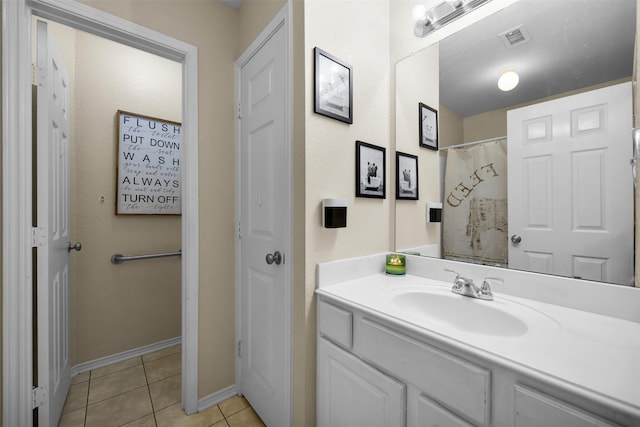 bathroom with visible vents, vanity, tile patterned flooring, and baseboards