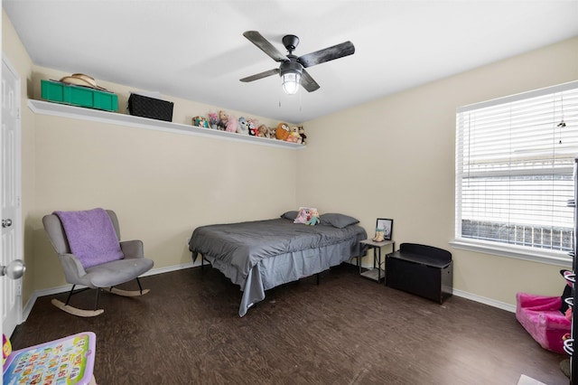 bedroom with baseboards, wood finished floors, and a ceiling fan