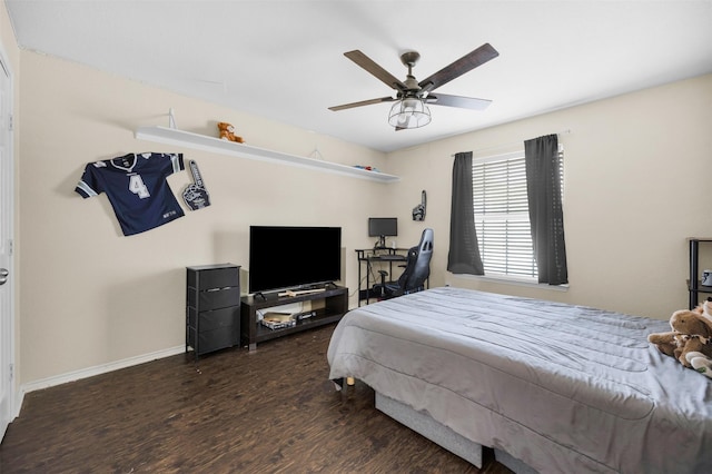 bedroom featuring baseboards, wood finished floors, and ceiling fan