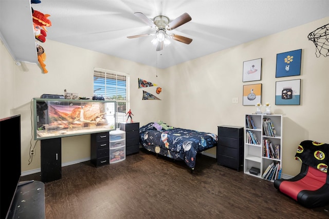 bedroom featuring wood finished floors, a ceiling fan, and baseboards