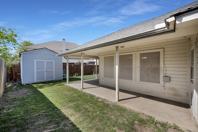 rear view of property featuring an outdoor structure, a fenced backyard, a storage shed, a patio, and a lawn