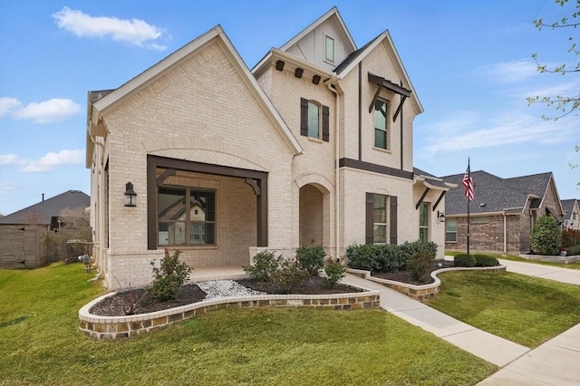 view of front of property with brick siding and a front yard