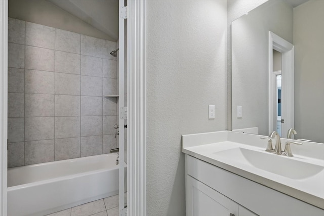 bathroom with bathing tub / shower combination, vanity, tile patterned flooring, and a textured wall