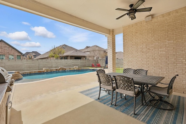 view of swimming pool with a fenced backyard, ceiling fan, outdoor dining space, and a patio area