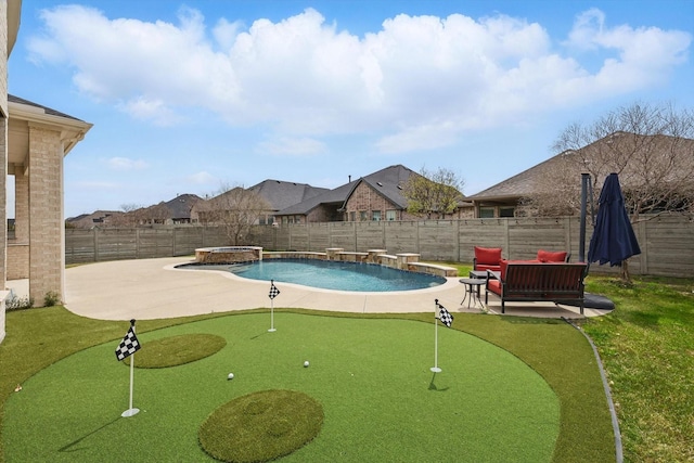 view of pool featuring a putting area, a patio area, a fenced backyard, and a pool with connected hot tub