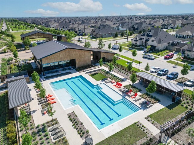 community pool featuring a residential view and central AC