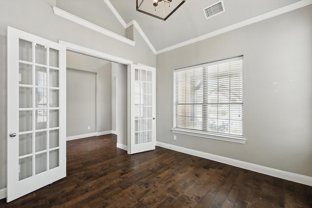spare room with lofted ceiling, french doors, a chandelier, baseboards, and wood finished floors