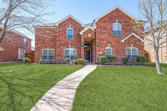traditional home with a front lawn and brick siding