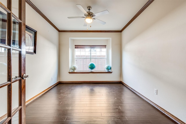 spare room with dark wood finished floors, a ceiling fan, baseboards, and crown molding
