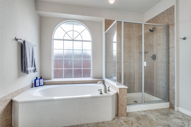 bathroom with a shower stall and a garden tub