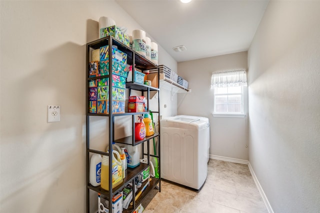 laundry area with washer / dryer, tile patterned flooring, baseboards, and laundry area