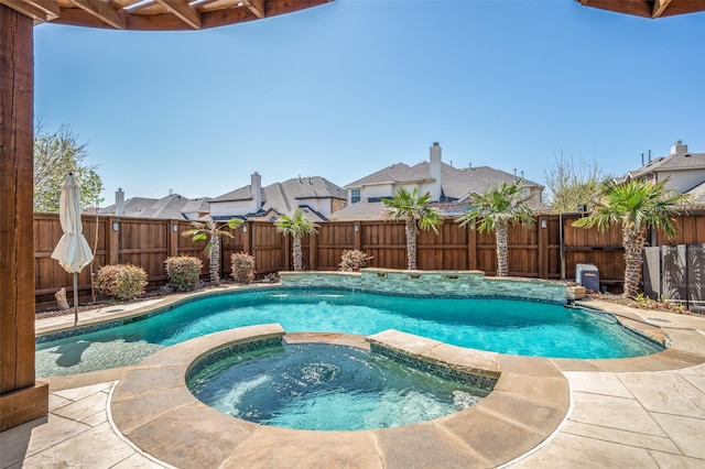 view of swimming pool with a residential view, a fenced backyard, and a pool with connected hot tub