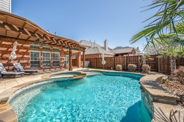 view of swimming pool featuring a pool with connected hot tub, a fenced backyard, a patio, and ceiling fan