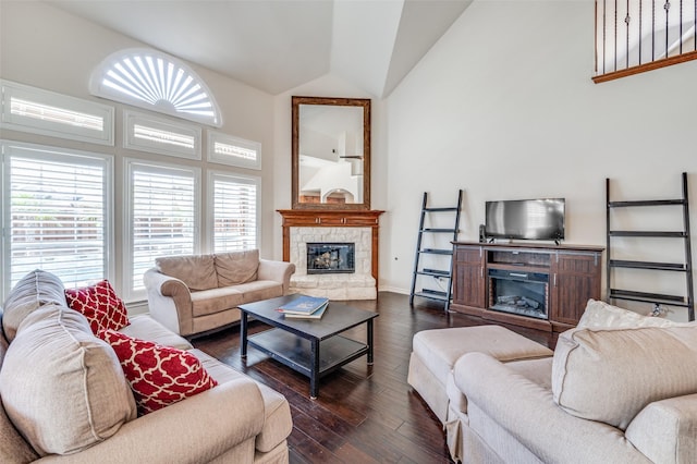 living room with lofted ceiling, baseboards, dark wood-style floors, and a fireplace