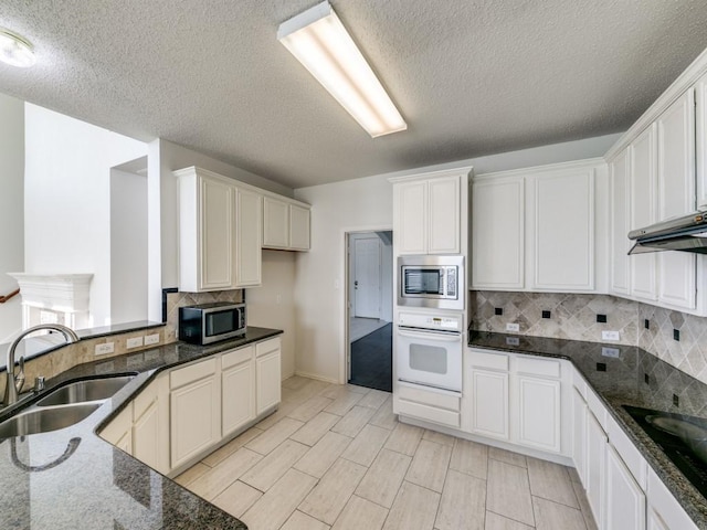 8317 Spring Valley Ln, Plano, TX 75025 - kitchen with a sink, stainless steel microwave, black electric cooktop, and oven