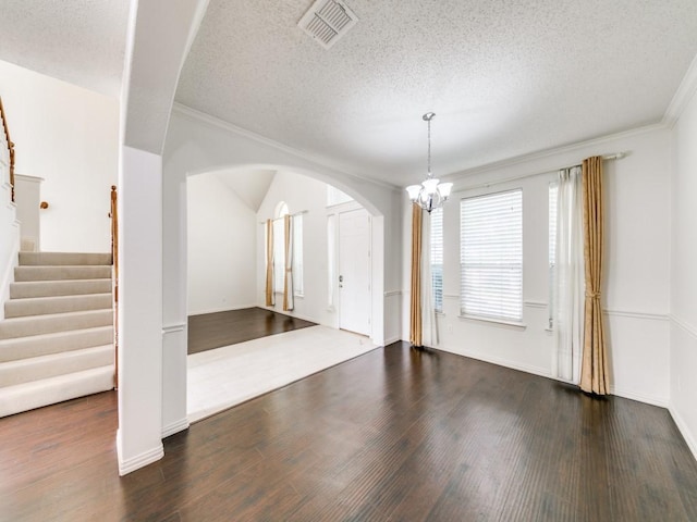 8317 Spring Valley Ln, Plano, TX 75025 - unfurnished room with visible vents, stairs, an inviting chandelier, and wood finished floors