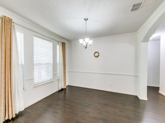 8317 Spring Valley Ln, Plano, TX 75025 - empty room featuring visible vents, wood finished floors, arched walkways, an inviting chandelier, and crown molding