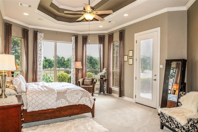 bedroom featuring access to exterior, light colored carpet, ornamental molding, baseboards, and a tray ceiling