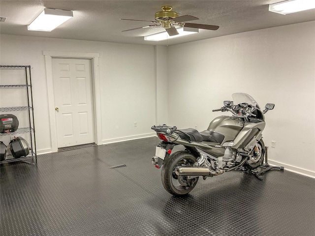 miscellaneous room with a ceiling fan and baseboards