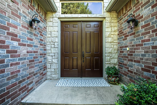 property entrance with brick siding