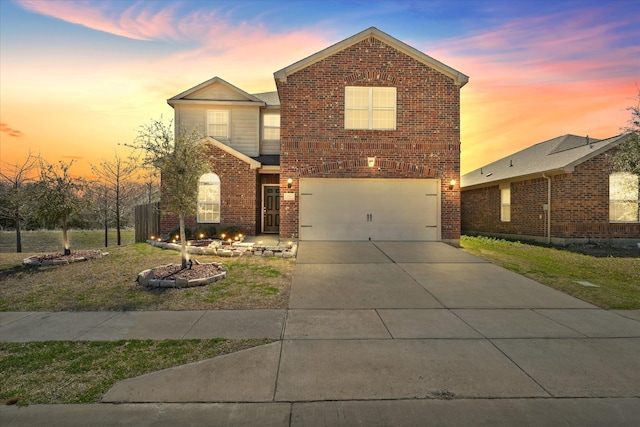 traditional-style house with brick siding, concrete driveway, and an attached garage