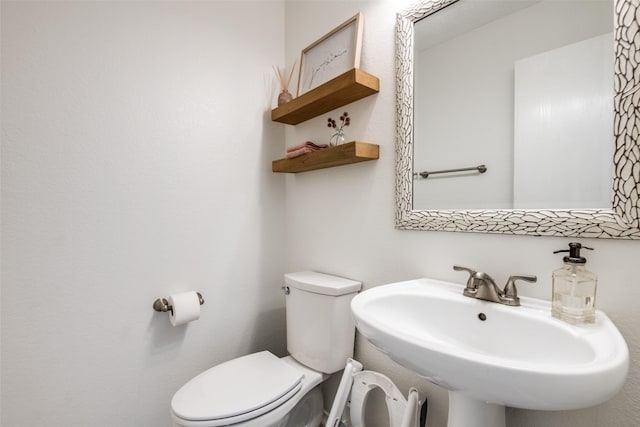 bathroom with toilet and a sink