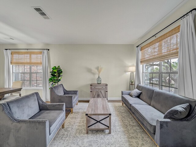 dining room featuring arched walkways, visible vents, wood finished floors, and baseboards