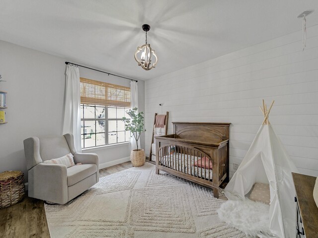 bedroom with a ceiling fan, wood finished floors, and baseboards