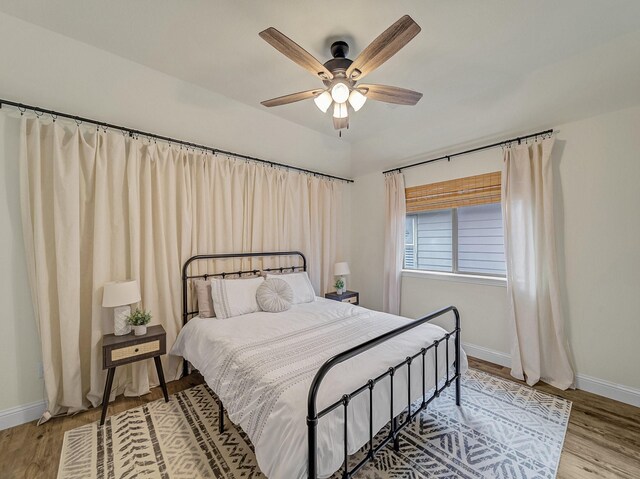 bedroom with baseboards, visible vents, and light wood-style floors