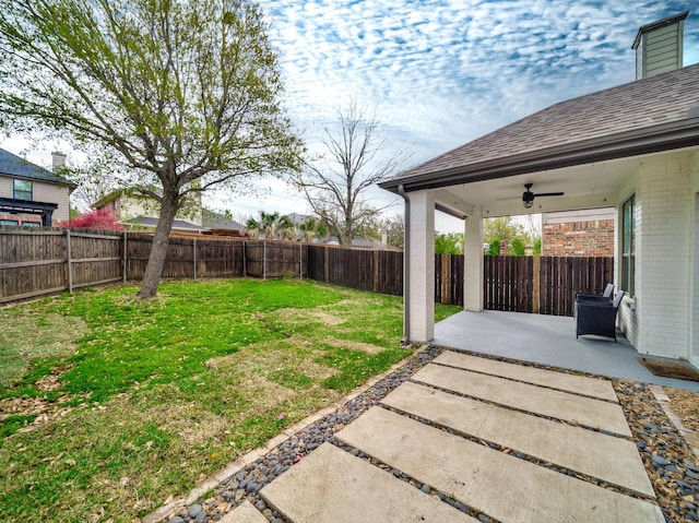 view of yard with ceiling fan, a patio, and a fenced backyard