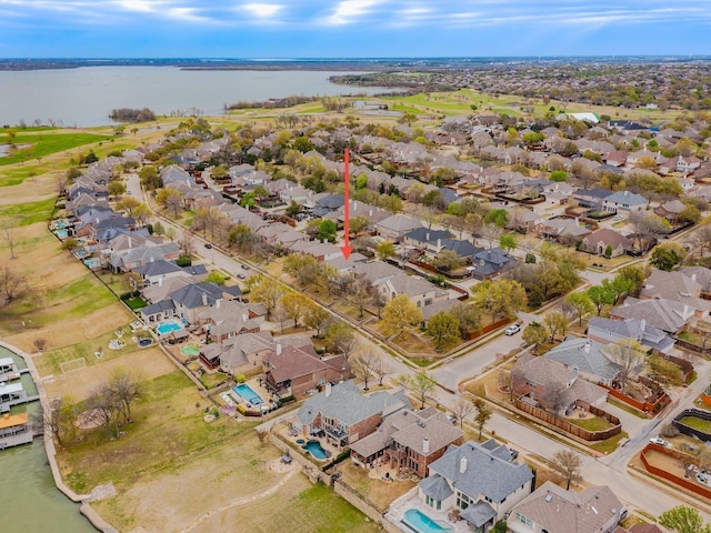 birds eye view of property featuring a water view and a residential view