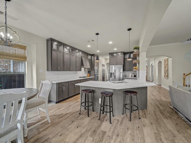 kitchen with stainless steel dishwasher, open shelves, a sink, gray cabinetry, and visible vents