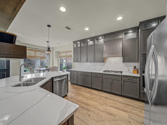 kitchen with recessed lighting, arched walkways, open shelves, and appliances with stainless steel finishes