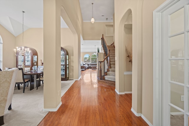 1192 Oak Hill Ln, Murphy, TX 75094 - foyer with stairs, a chandelier, light wood-type flooring, and baseboards